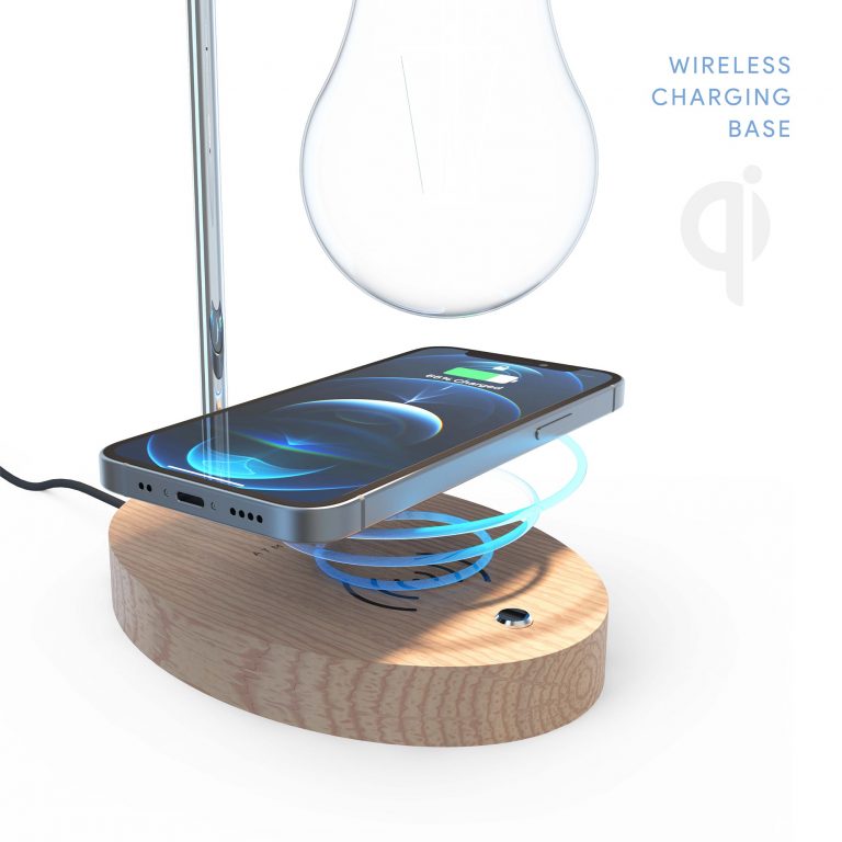 A smartphone is being charged on the lamp’s wireless charging base.