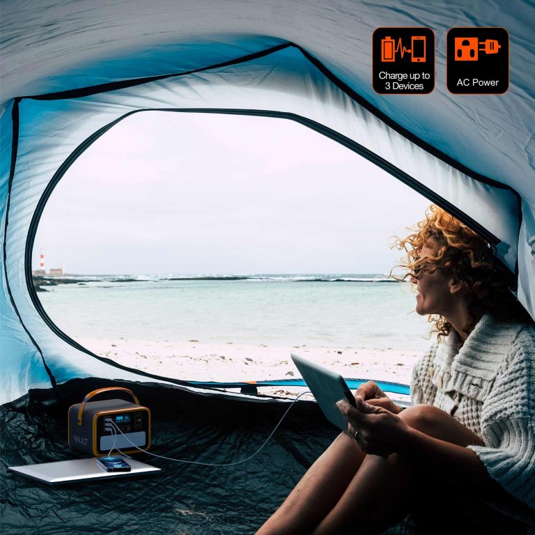 A young explorer on a camping trip using the Vault to simultaneously charge her smartphone, laptop, and tablet.